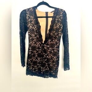 Black lace romper, tight and low cut.